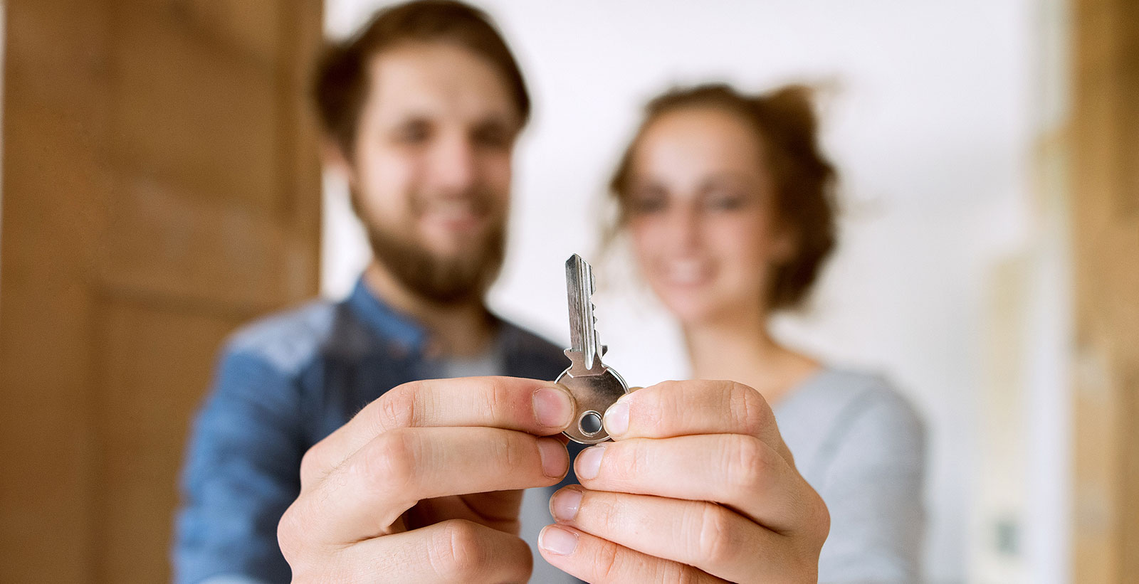 Happy couple holding the key of their new home